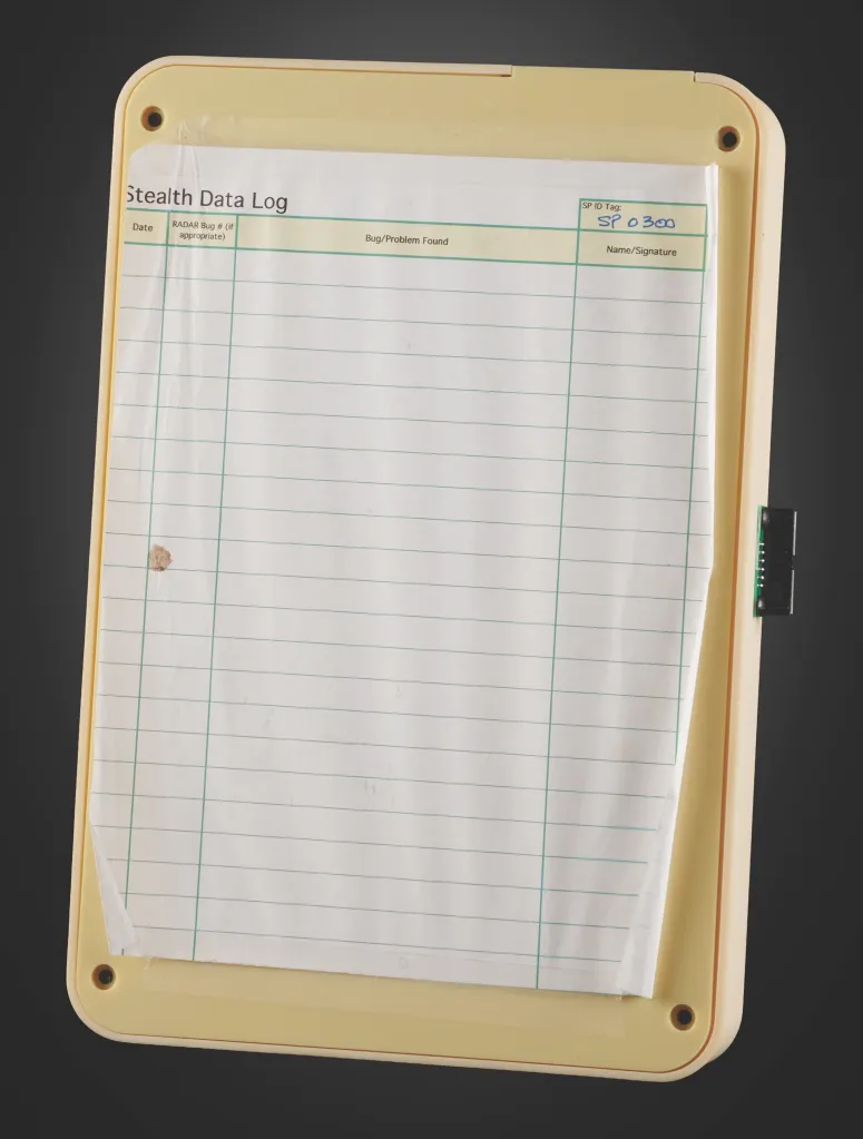 An original Apple P68 "Stealth iPod" development prototype, featuring a paper "Stealth Data Log" for recording bugs, with "SP 0300" handwritten under "SP ID Tag."