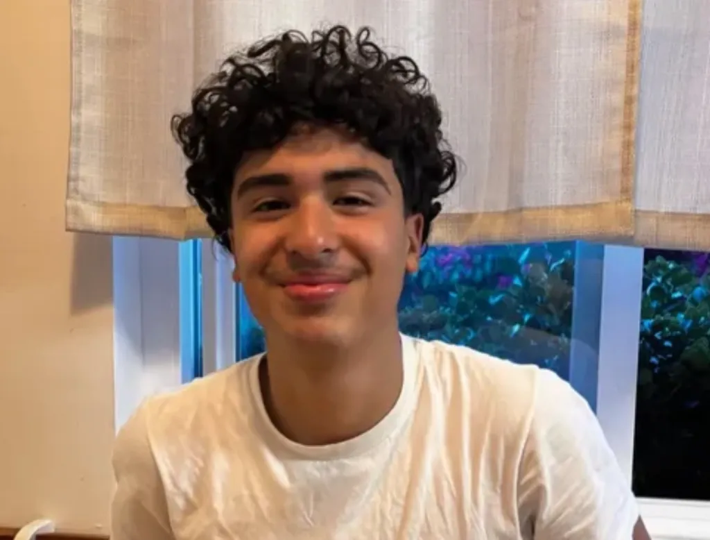Aziel Zacapala, a young man with curly hair and a slight smile.