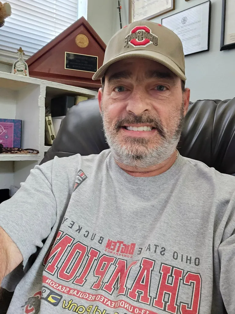 Bart Diguglielmo smiling while wearing an Ohio State hat and t-shirt.