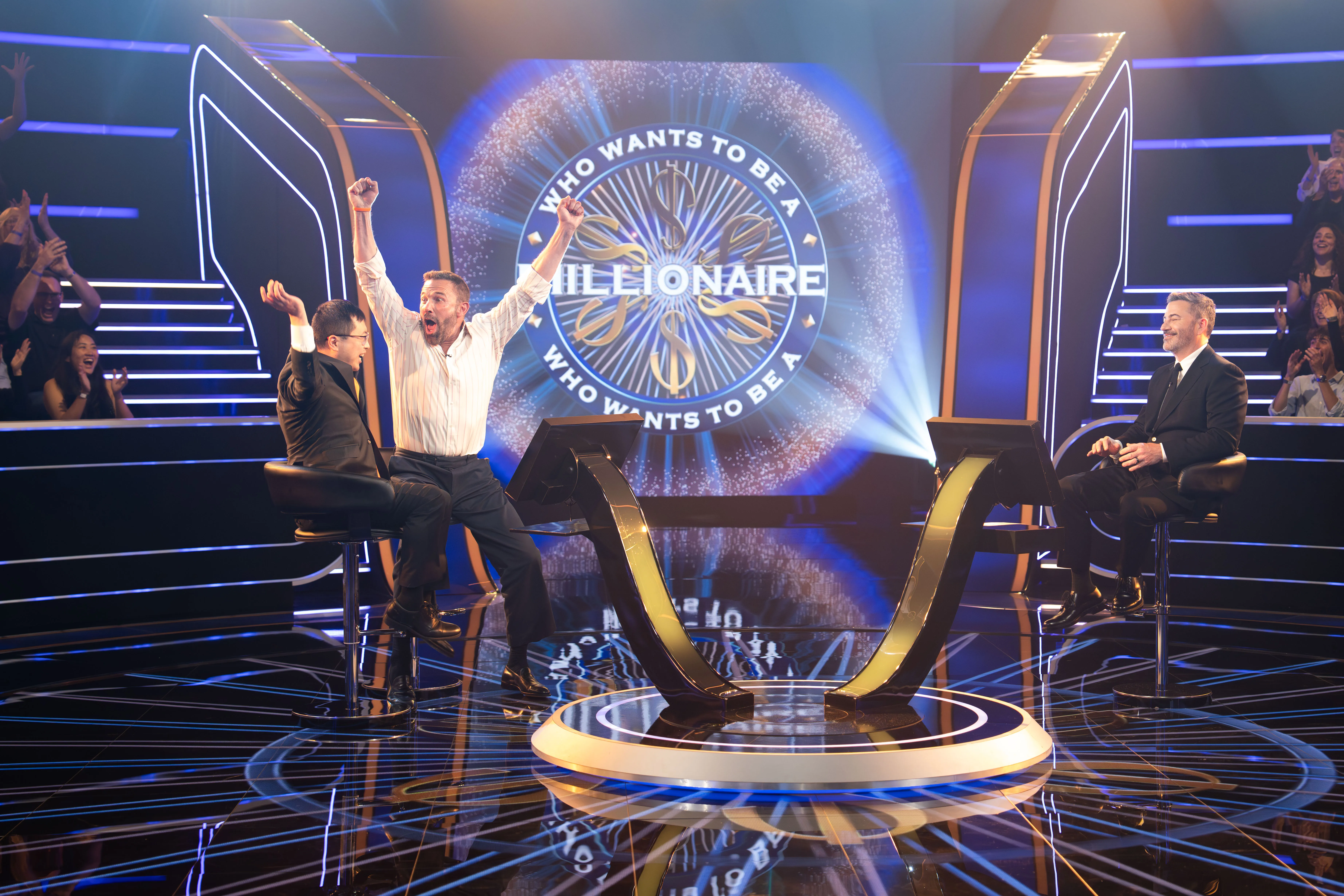 Ben Affleck and Jamie Ding celebrating with Jimmy Kimmel on "Who Wants to Be a Millionaire."