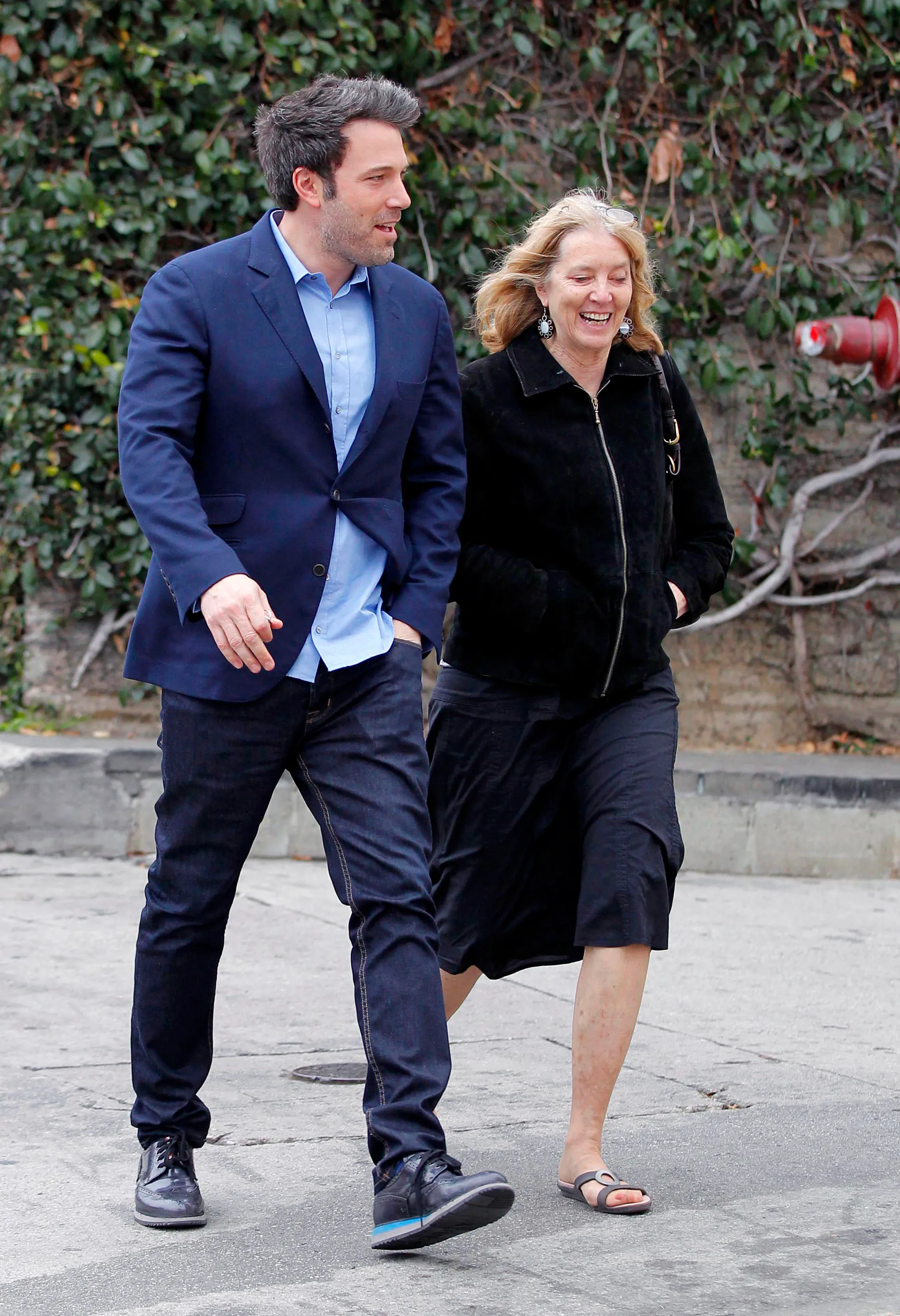 Ben Affleck and his mother, Chris Affleck, walk together.