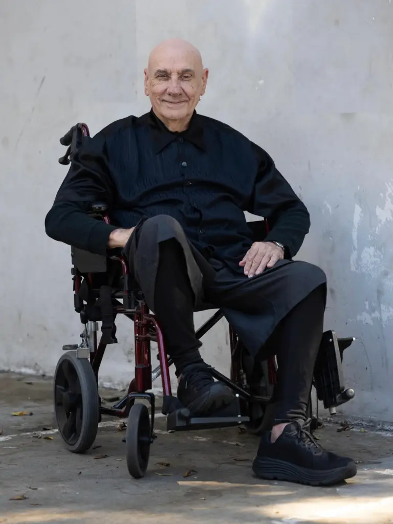 Bill Ward, drummer of Black Sabbath, seated in a wheelchair.