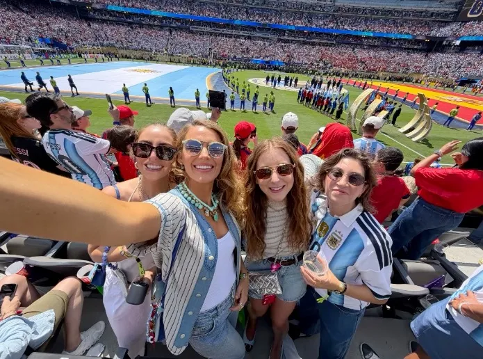 Blake Lively and three friends taking a selfie in the stands of a stadium during the World Cup Final.