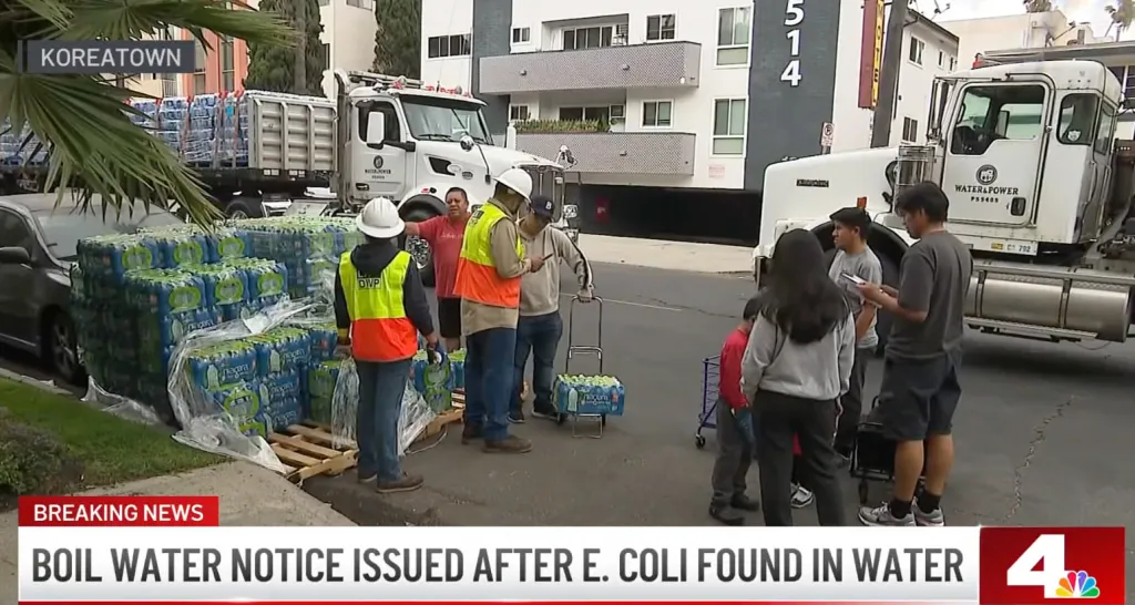Workers distributing bottled water in Koreatown due to a boil water notice.