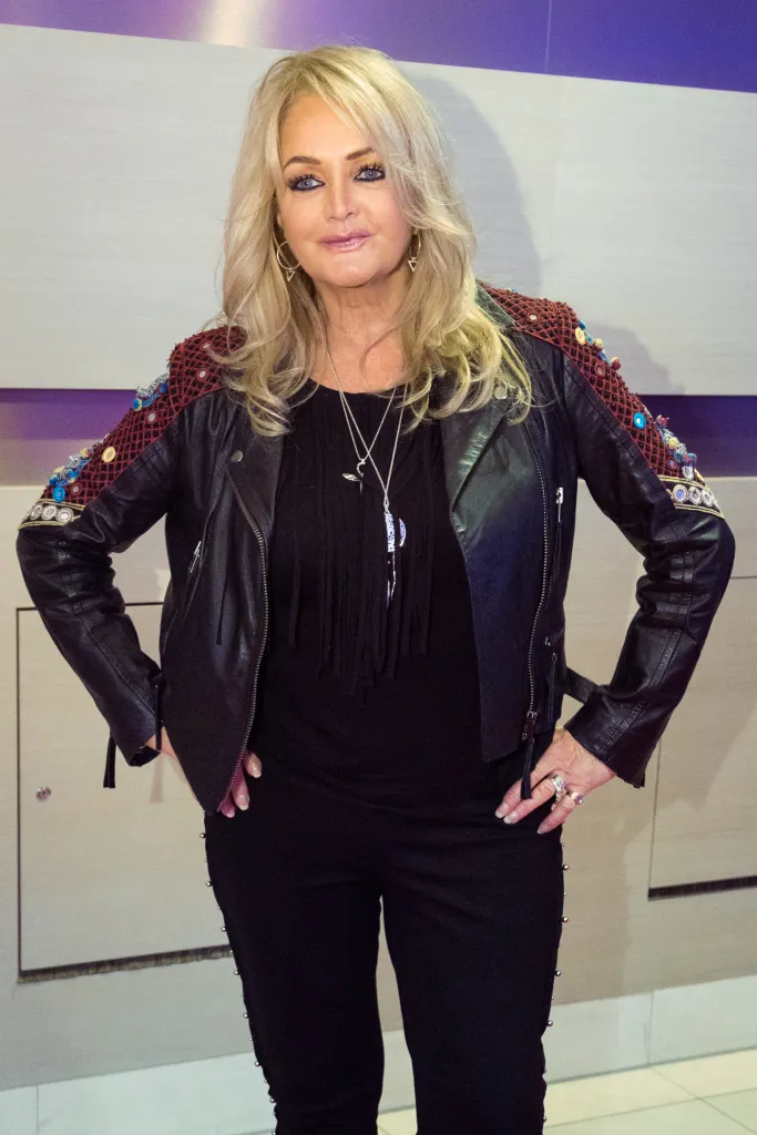 Bonnie Tyler in a black leather jacket with embroidered sleeves.