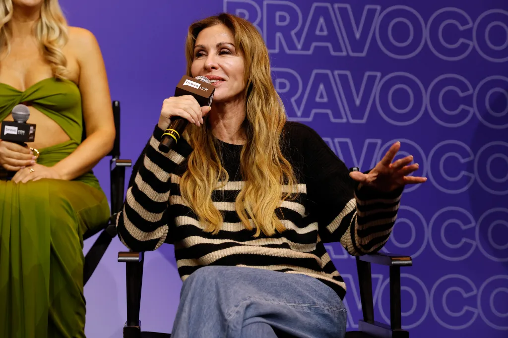 Carole Radziwill speaking into a microphone at BravoCon.