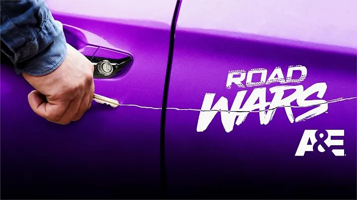 Hand keying a purple car with "ROAD WARS" and "A&E" logos.