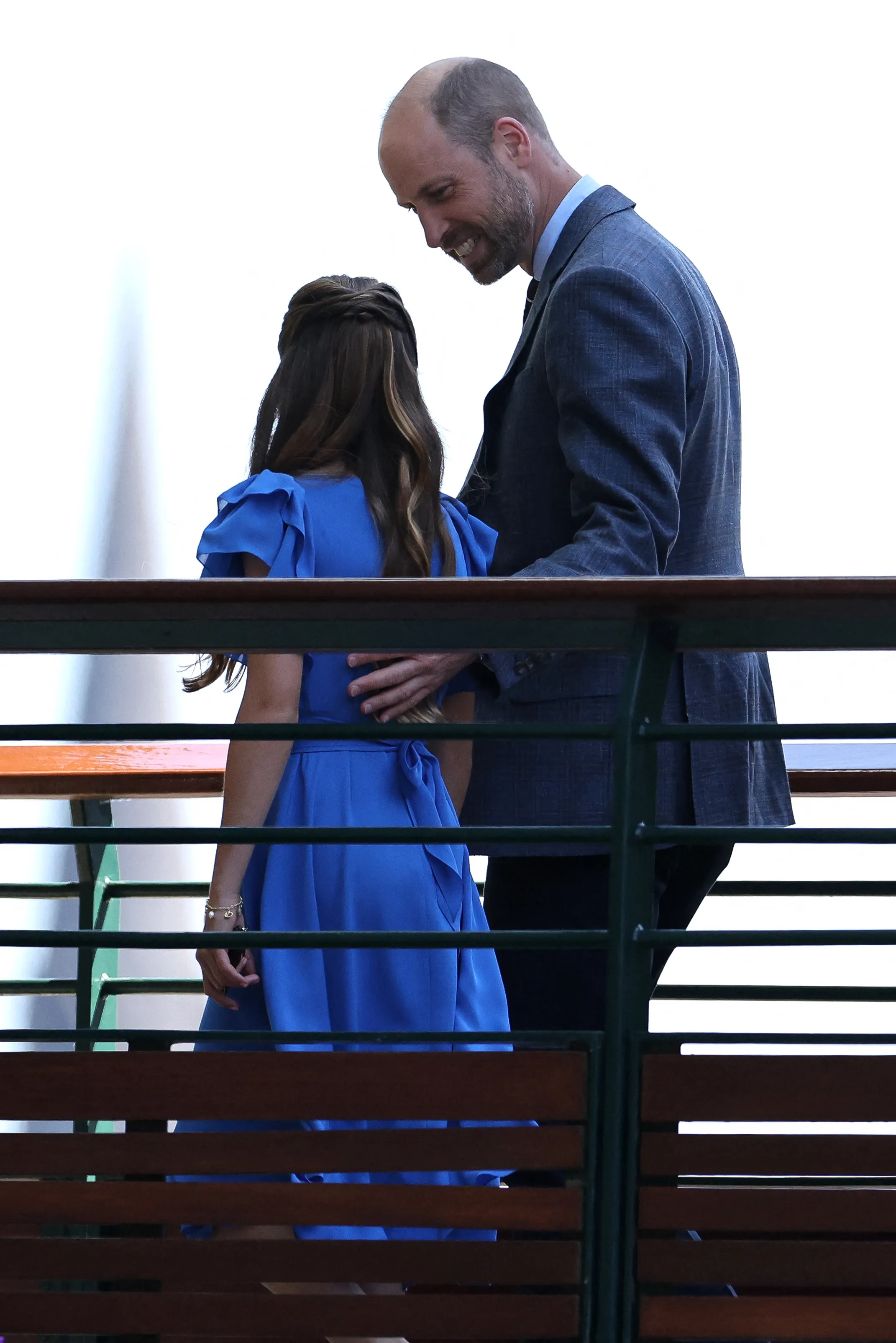 Prince William smiling at Princess Charlotte at the Wimbledon Championships.