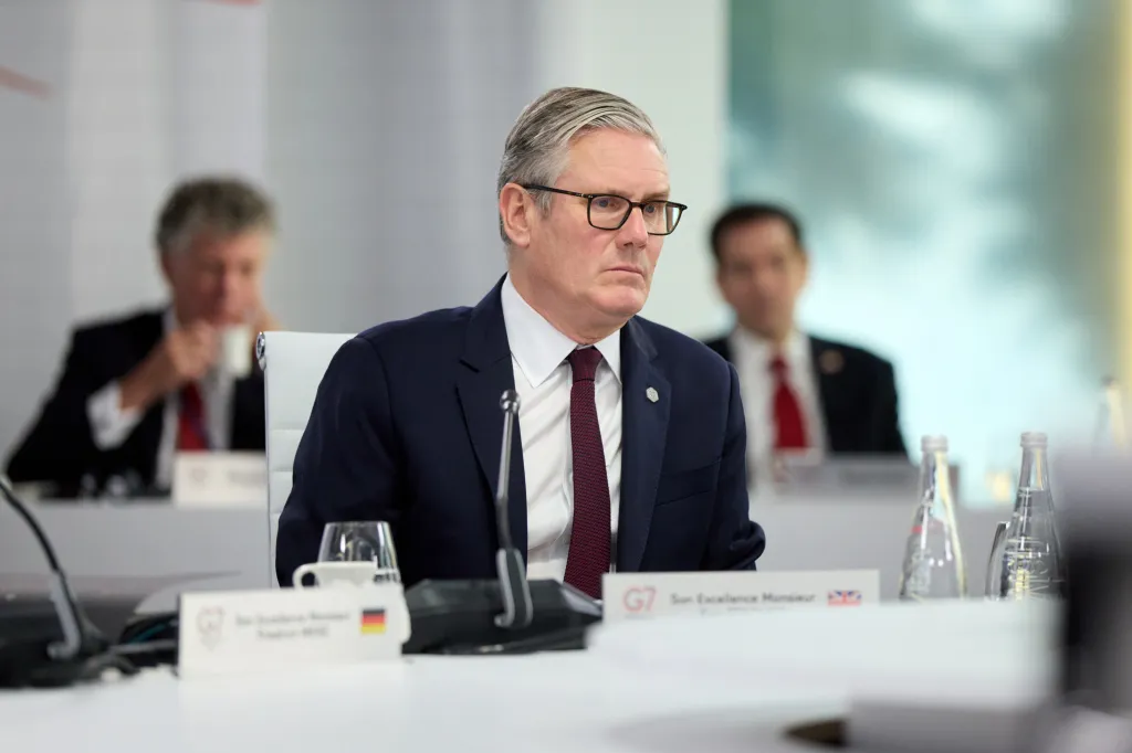 British Prime Minister Kier Starmer sits at a table during a G7 Summit discussion.