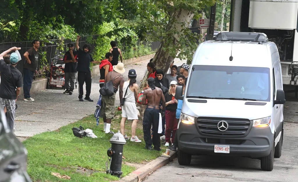 Clients line up on East 175th St. in the Bronx outside a needle buy back van.