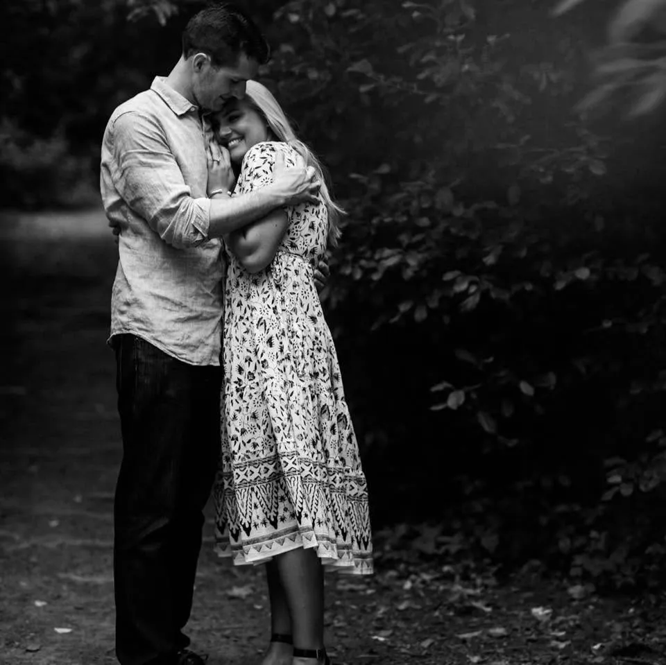 A man embracing a woman who is smiling.