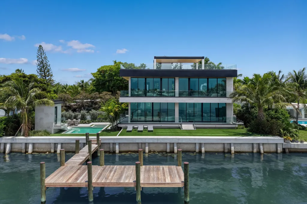 The home features a pool, spa, putting green, and a dock.