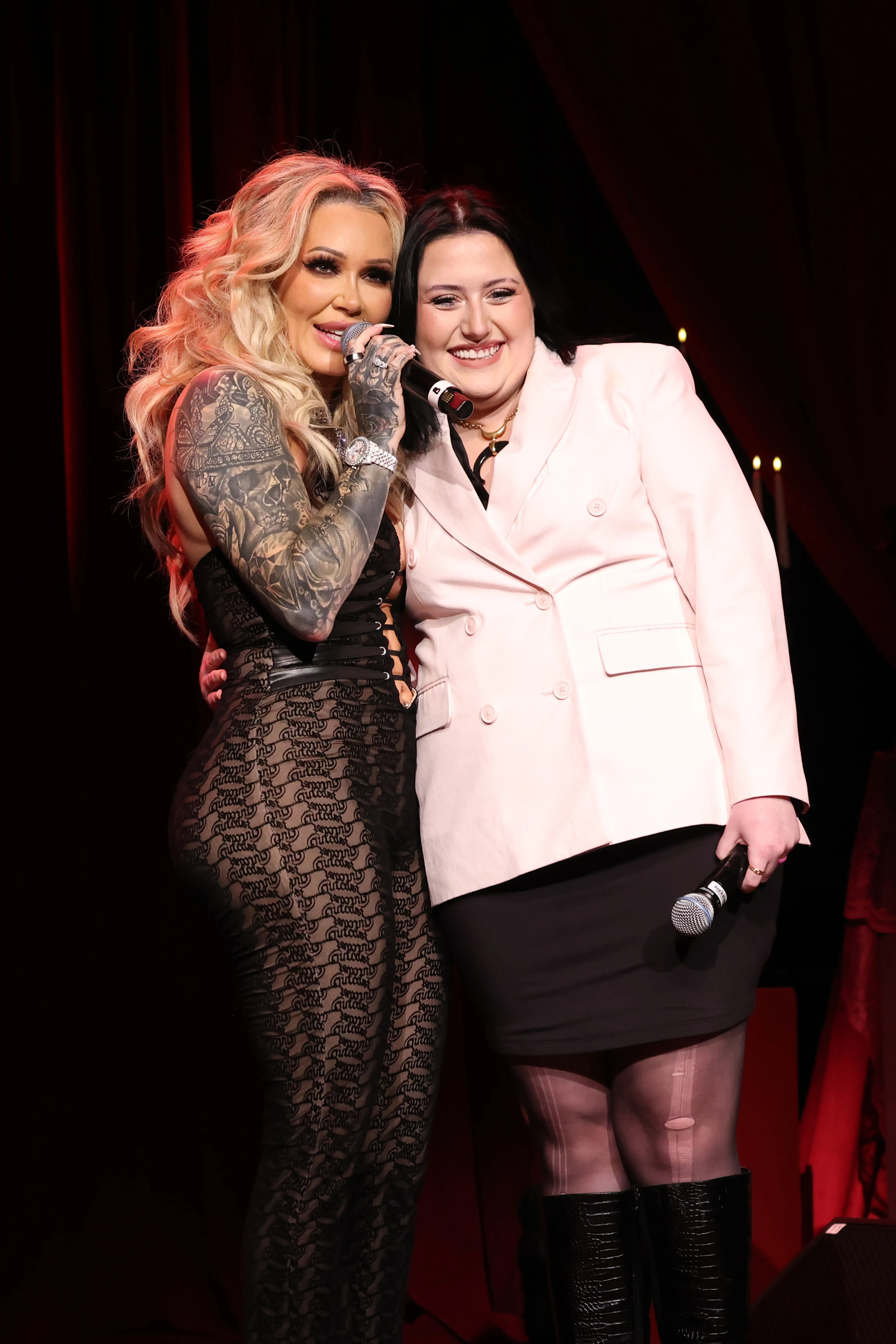 Bunnie XO and Bailee Ann DeFord speaking onstage with microphones.