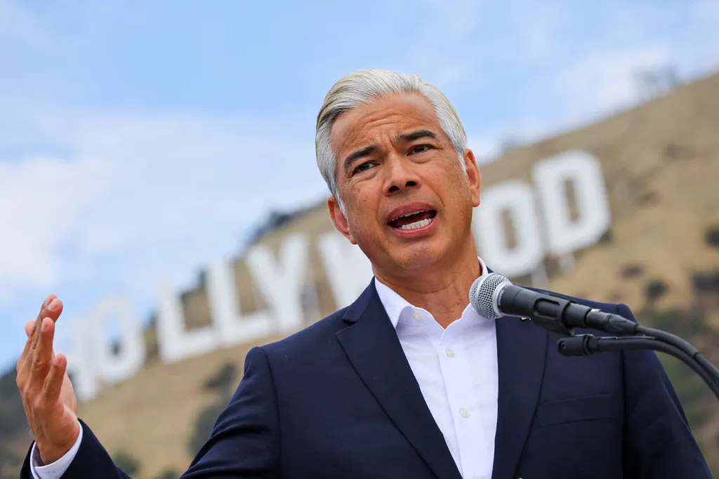 California Attorney General Rob Bonta holding a press conference with the Hollywood sign in the background.
