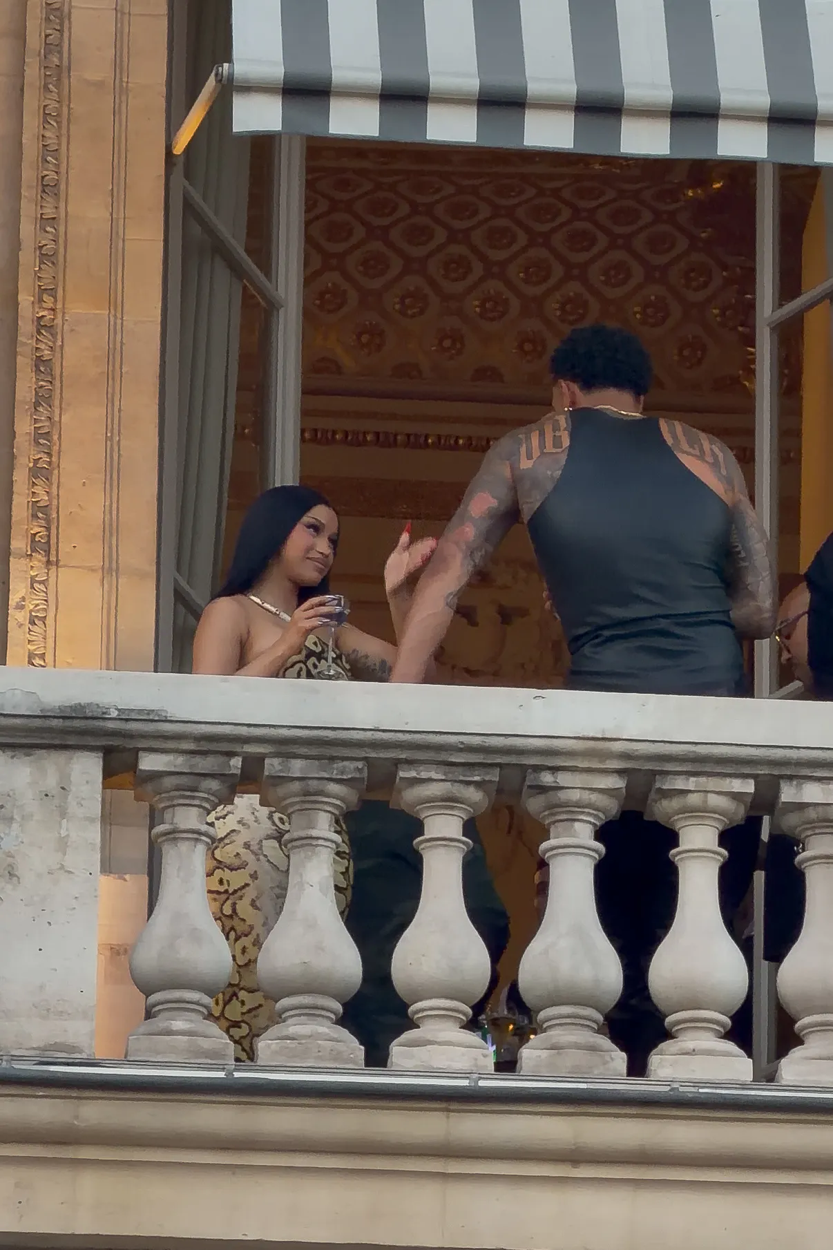 Cardi B and Maduka Okoye on a terrace in Paris.