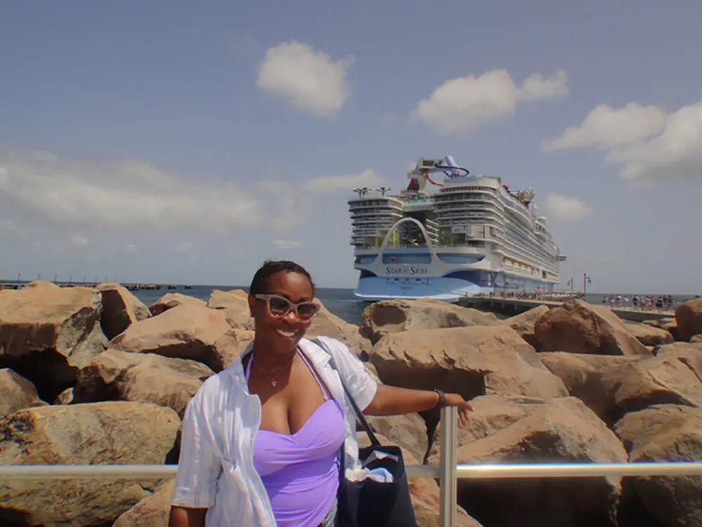 Carol Nicole in front of a cruise ship.