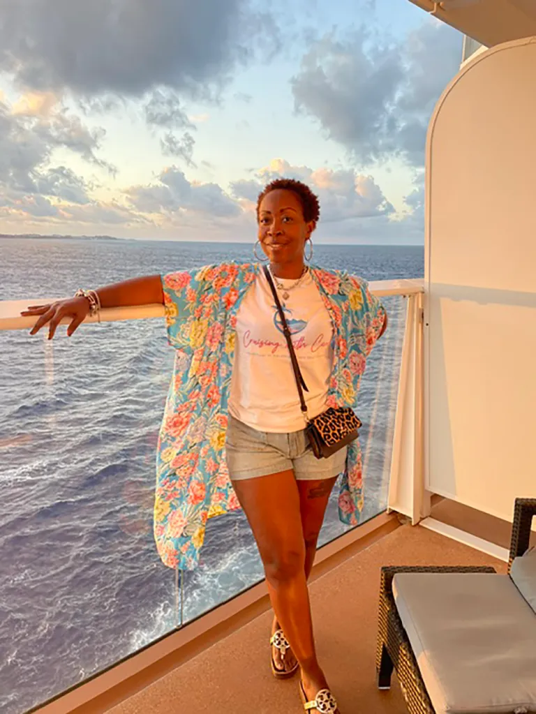 Carol Nicole posing on a cruise ship balcony.