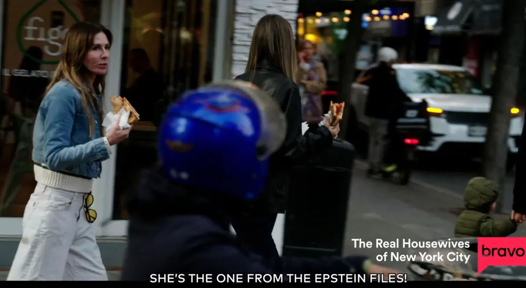 Carole Radziwill walking down a city street while eating from a sandwich, with the Bravo logo in the corner.
