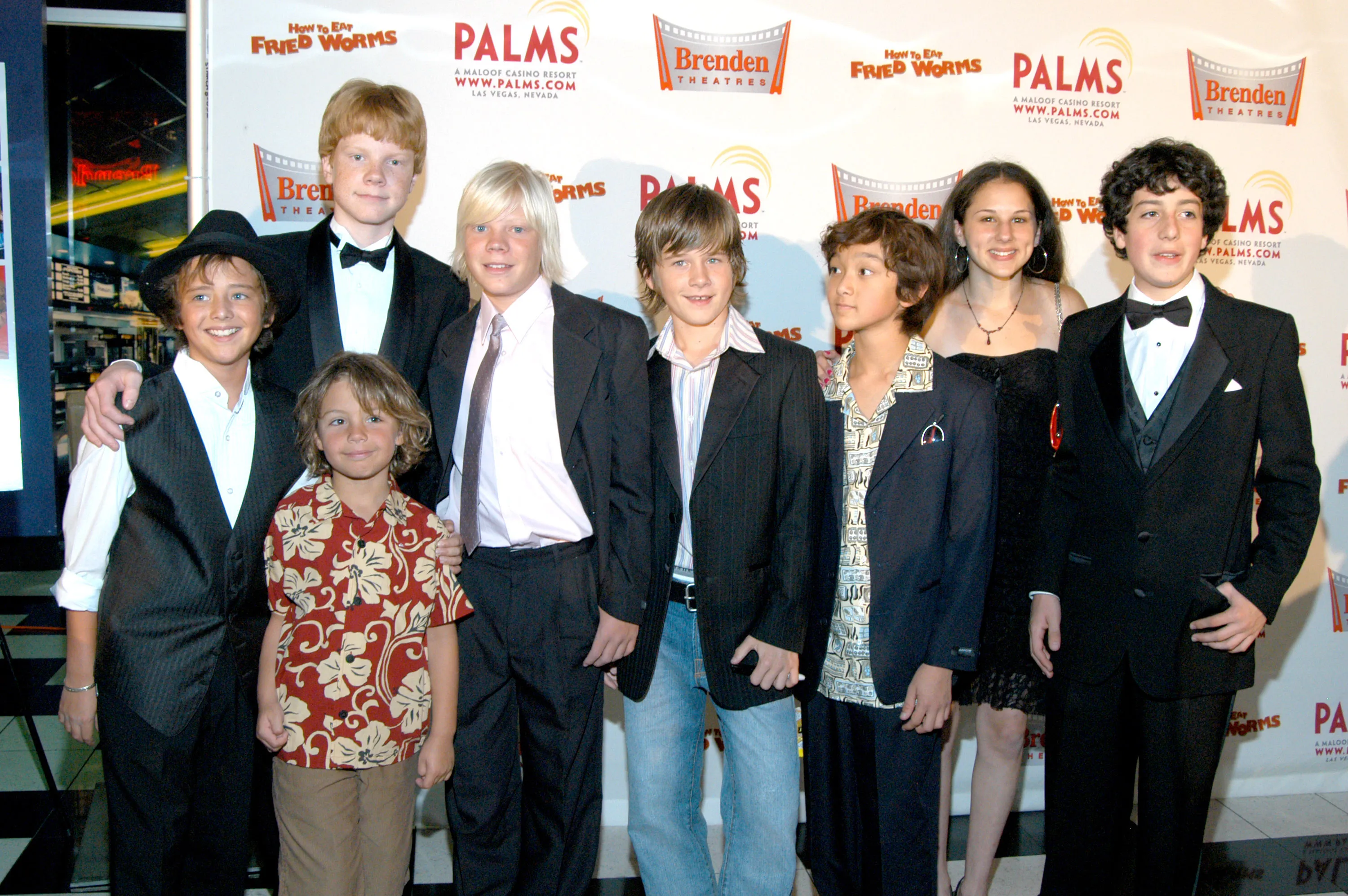 The cast of How to Eat Fried Worms smiling at the movie premiere.