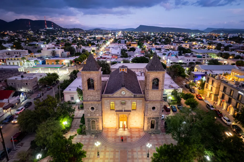 Aerial view of the Cathedral of La Paz and the surrounding city at dusk.