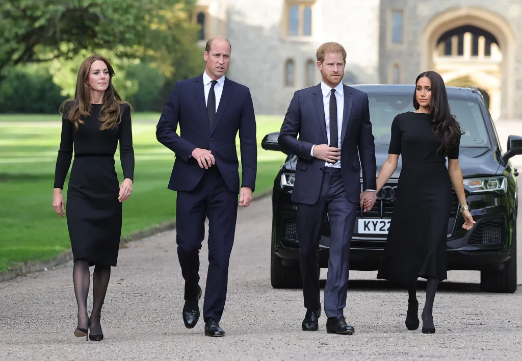 Catherine, Princess of Wales, Prince William, Prince of Wales, Prince Harry, Duke of Sussex, and Meghan, Duchess of Sussex, walk toward viewers.