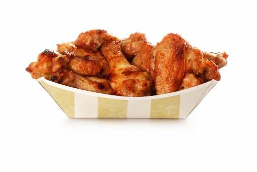 Chicken wings in a take-out container.