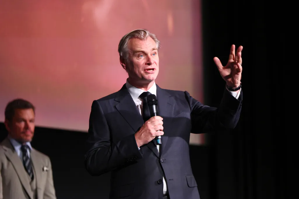 Christopher Nolan speaking onstage at "The Odyssey" London Premiere.