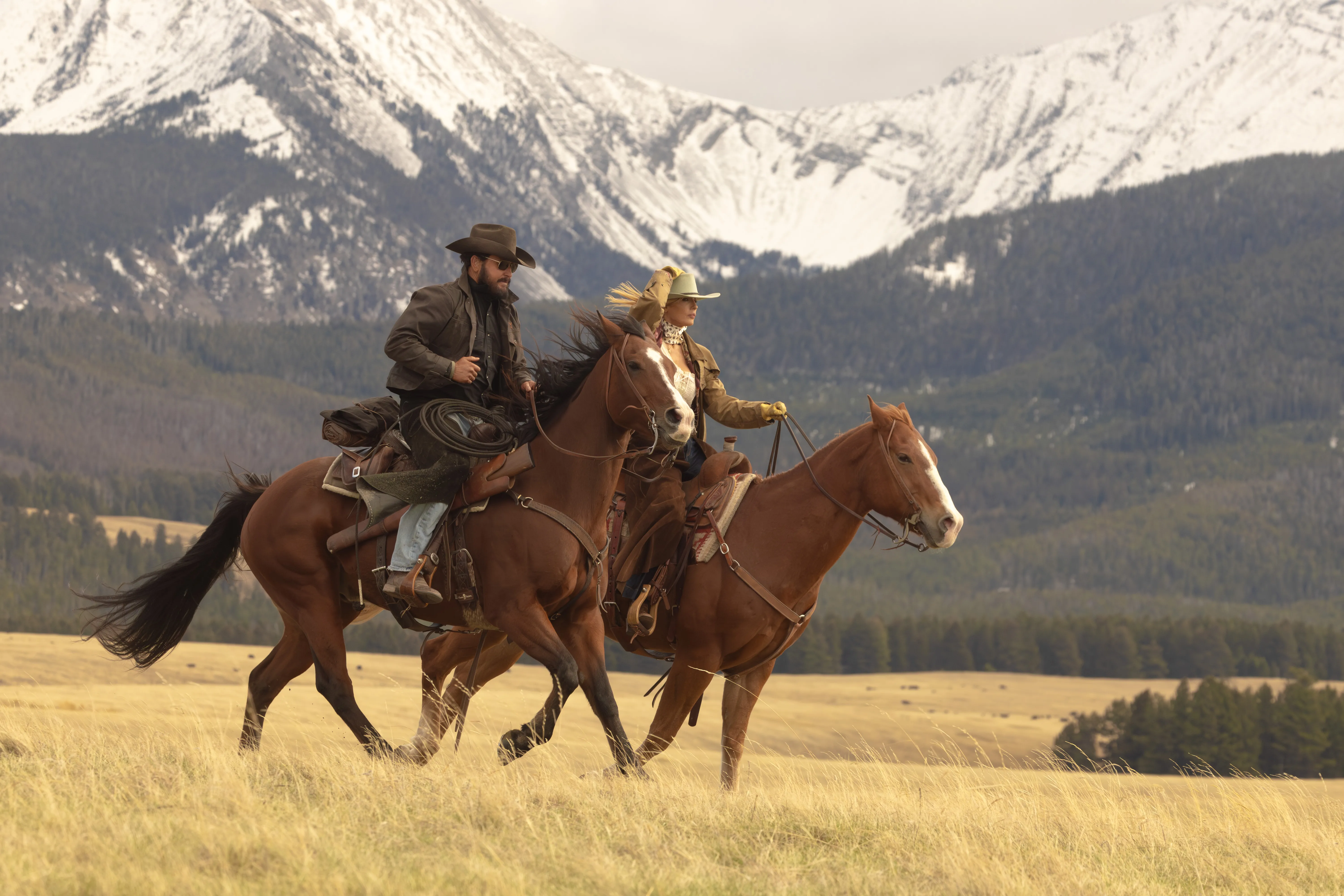 Cole Hauser as Rip Wheeler and Kelly Reilly as Beth Dutton riding horses.