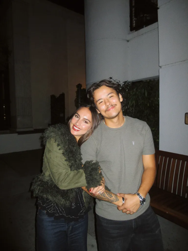 Collin Gosselin and a woman smiling and holding arms, standing outdoors at night.