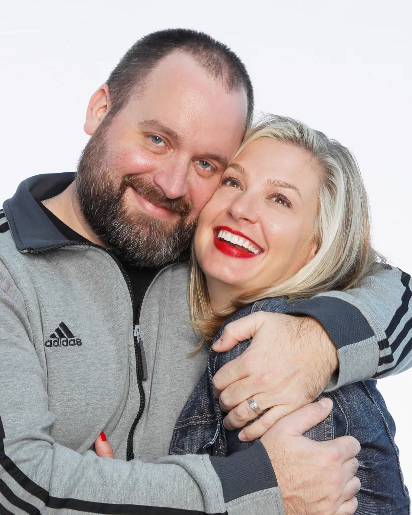 Comedians Tom Segura and Christina Pazsitzky posing together.