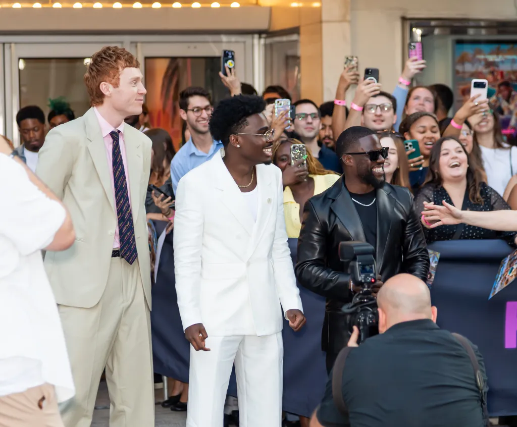 Comedians Ben Marshall, Kam Patterson, and Kevin Hart posing with fans at a movie screening.