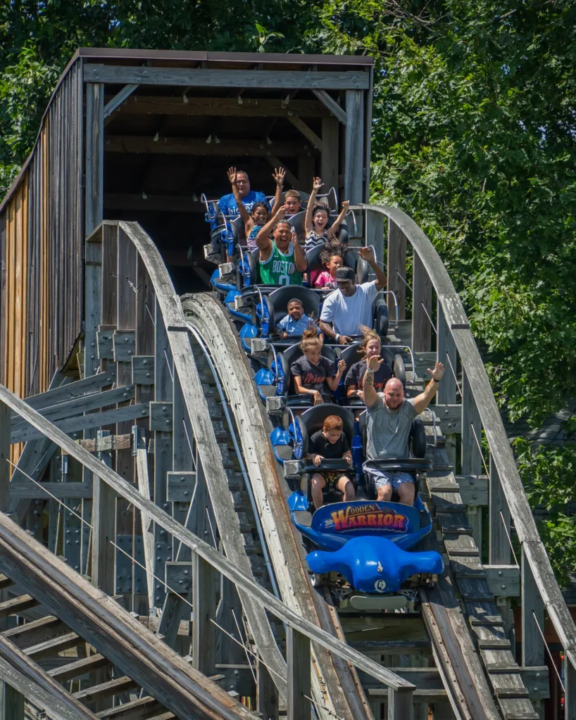 People riding the Wooden Warrior roller coaster at Quassy Amusement Park.