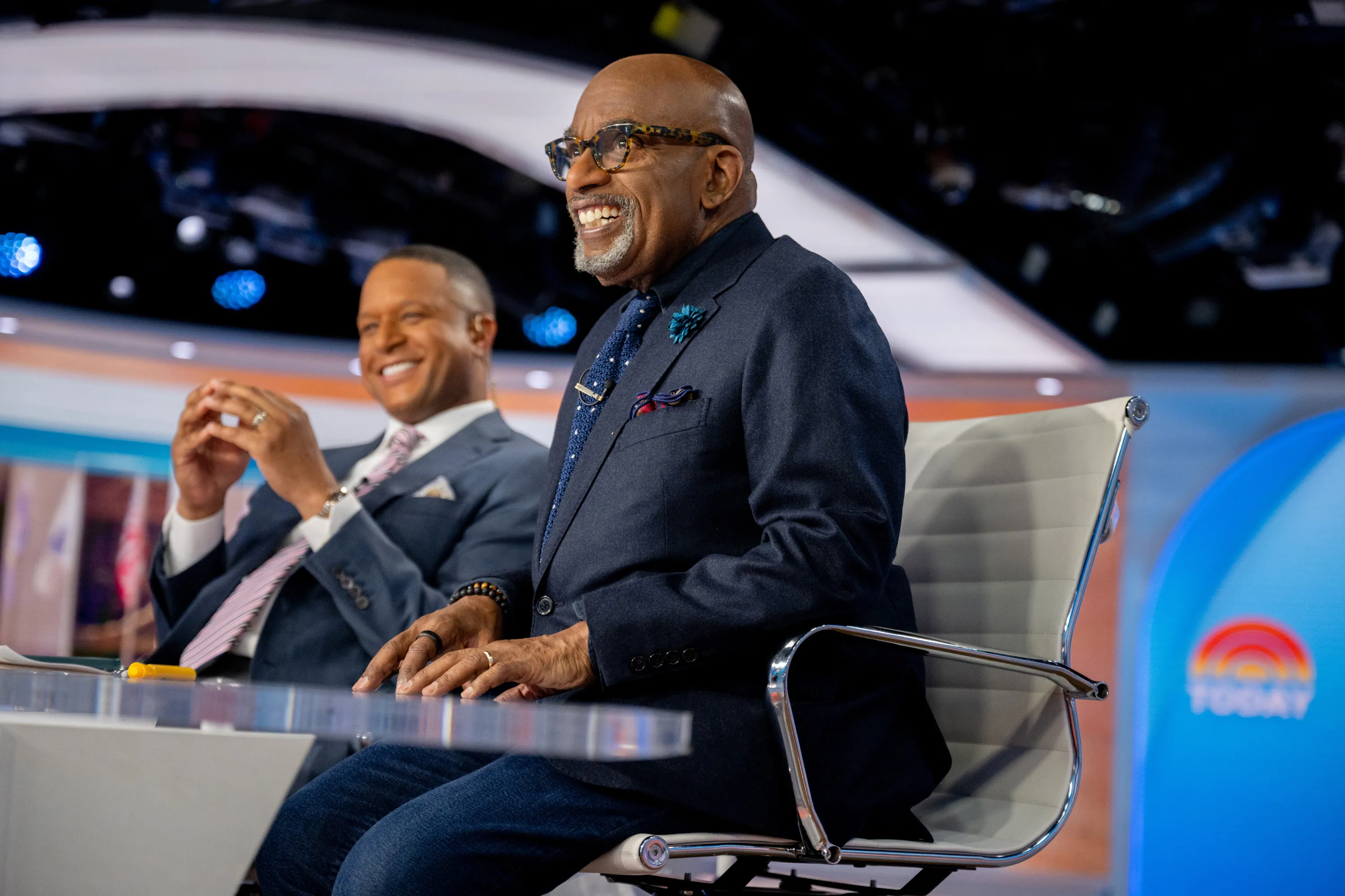 Al Roker smiles while seated next to Craig Melvin, who is also smiling, on the TODAY set.