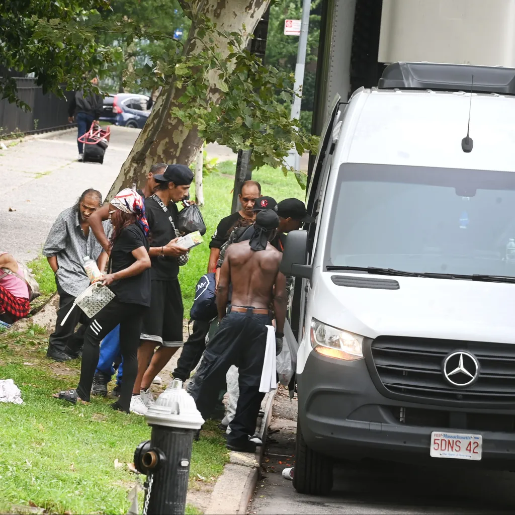 Clients line up on East 175th St. in The Bronx outside a needle-buy back van.