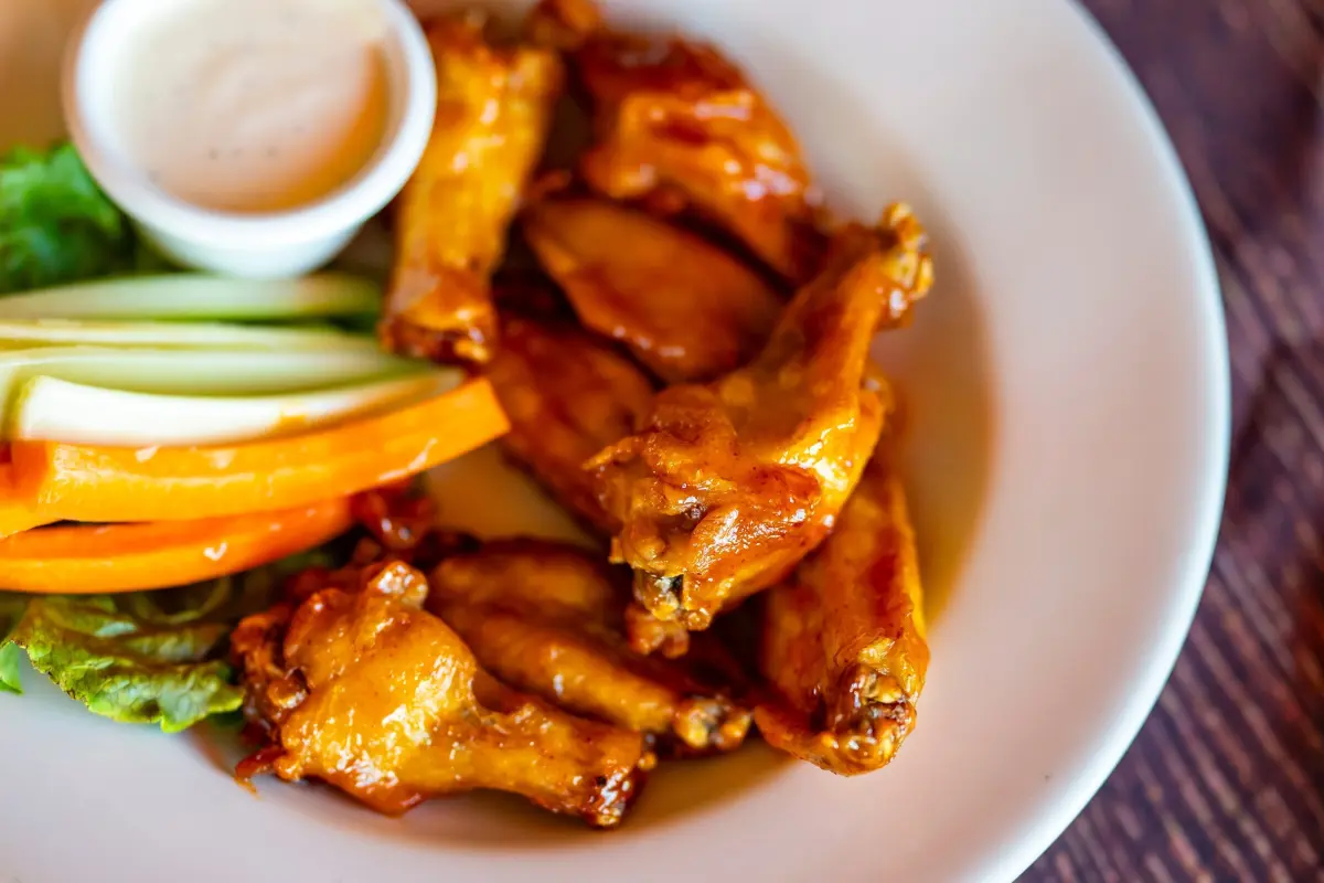 Chicken wing prices are down —but your favorite restaurant may not cut costs