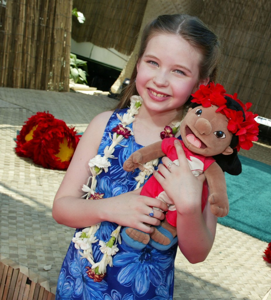 Daveigh Chase, voice of Lilo, holding a Lilo plush doll at the "Lilo & Stitch" premiere.