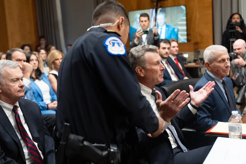 David Schertler, Dr. Anthony Fauci’s defense lawyer, is escorted out as Fauci appears before the Senate Homeland Security and Governmental Affairs Committee.