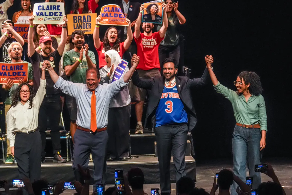 Claire Valdez, Brad Lander, Darializa Avila, and Zohran Mamdani on stage at a Get Out The Vote rally.