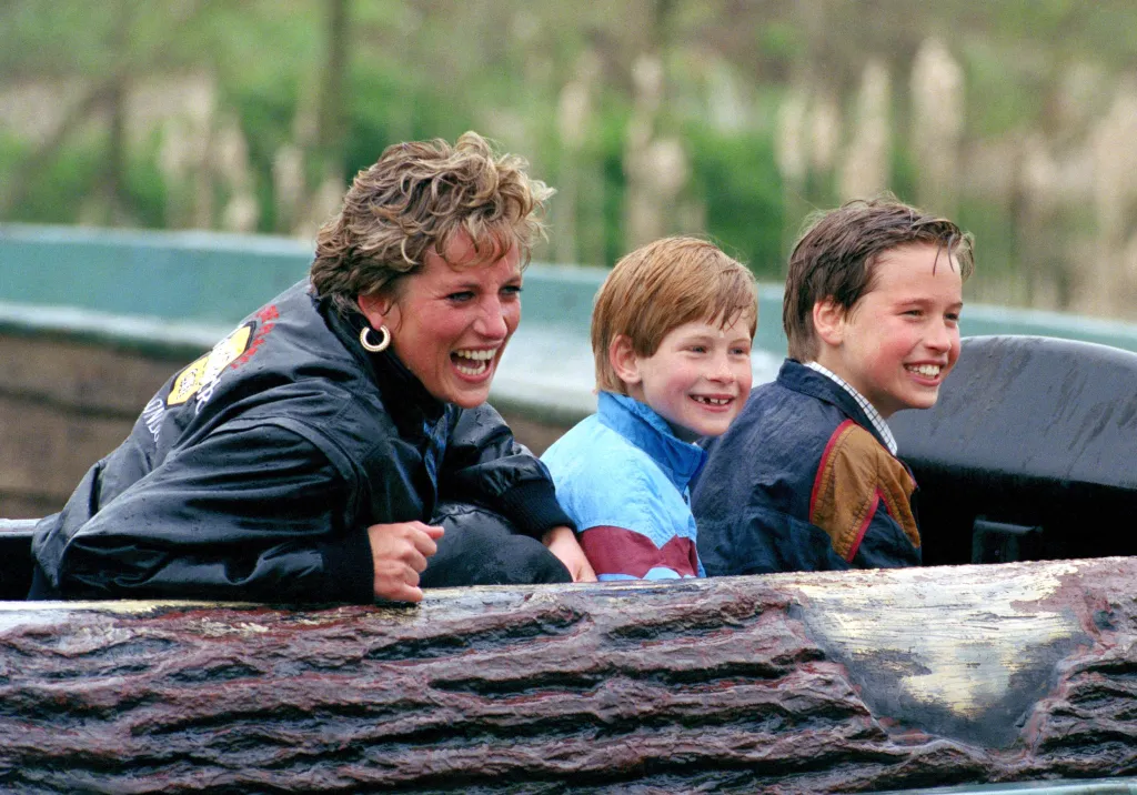 Diana, Princess of Wales, Prince William, and Prince Harry laughing while riding a log flume at Thorpe Park.