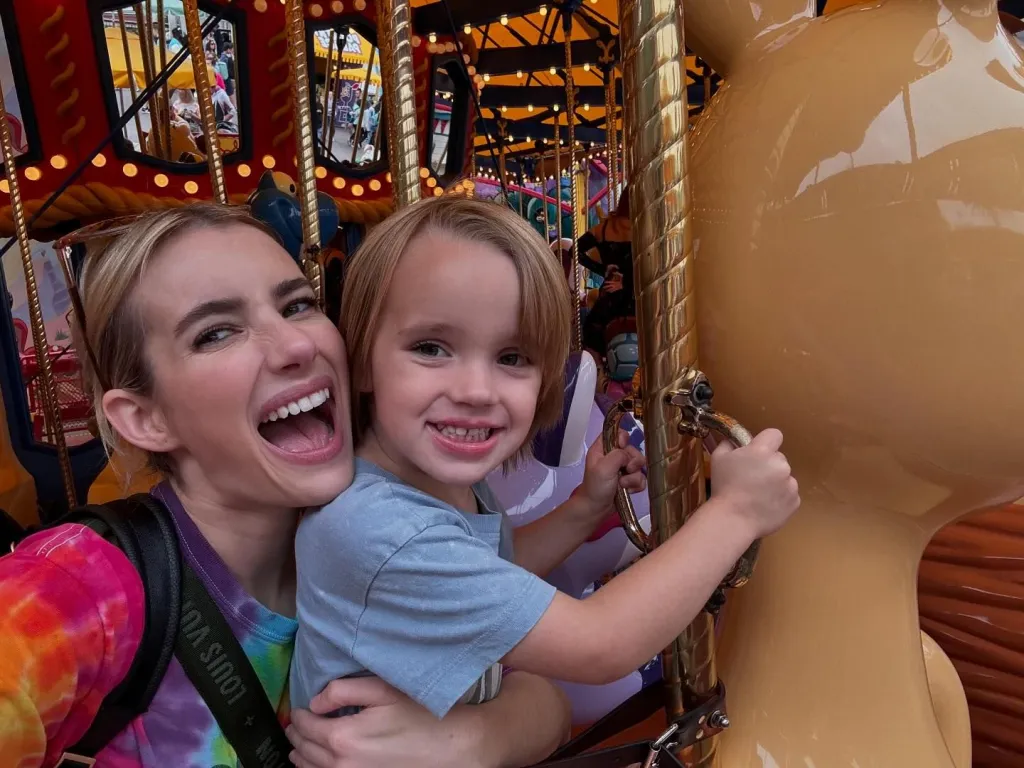 Emma Roberts and her son on a carousel at Disneyland.