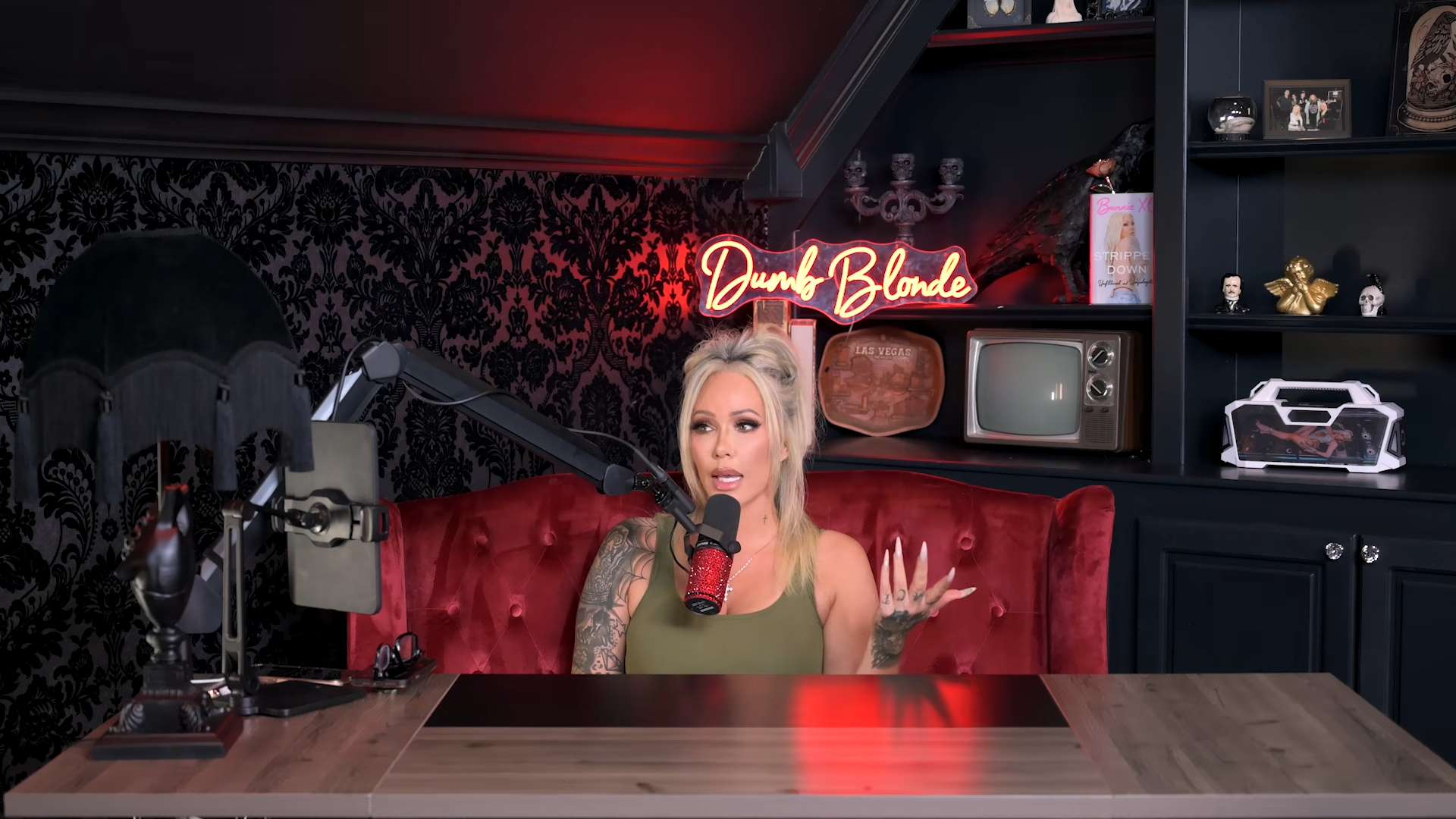 Bunnie XO speaking into a microphone on her "Dumb Blonde" podcast.