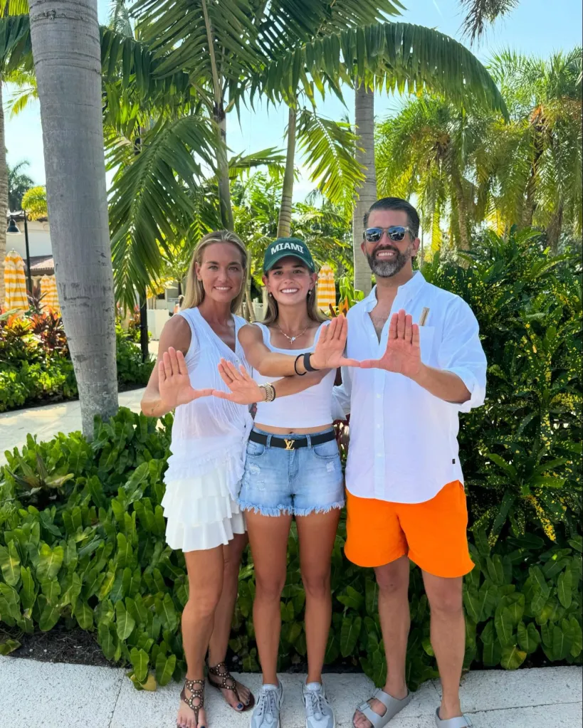 Donald Trump Jr., Vanessa Trump, and their daughter Kai Trump, standing outdoors making a hand gesture.
