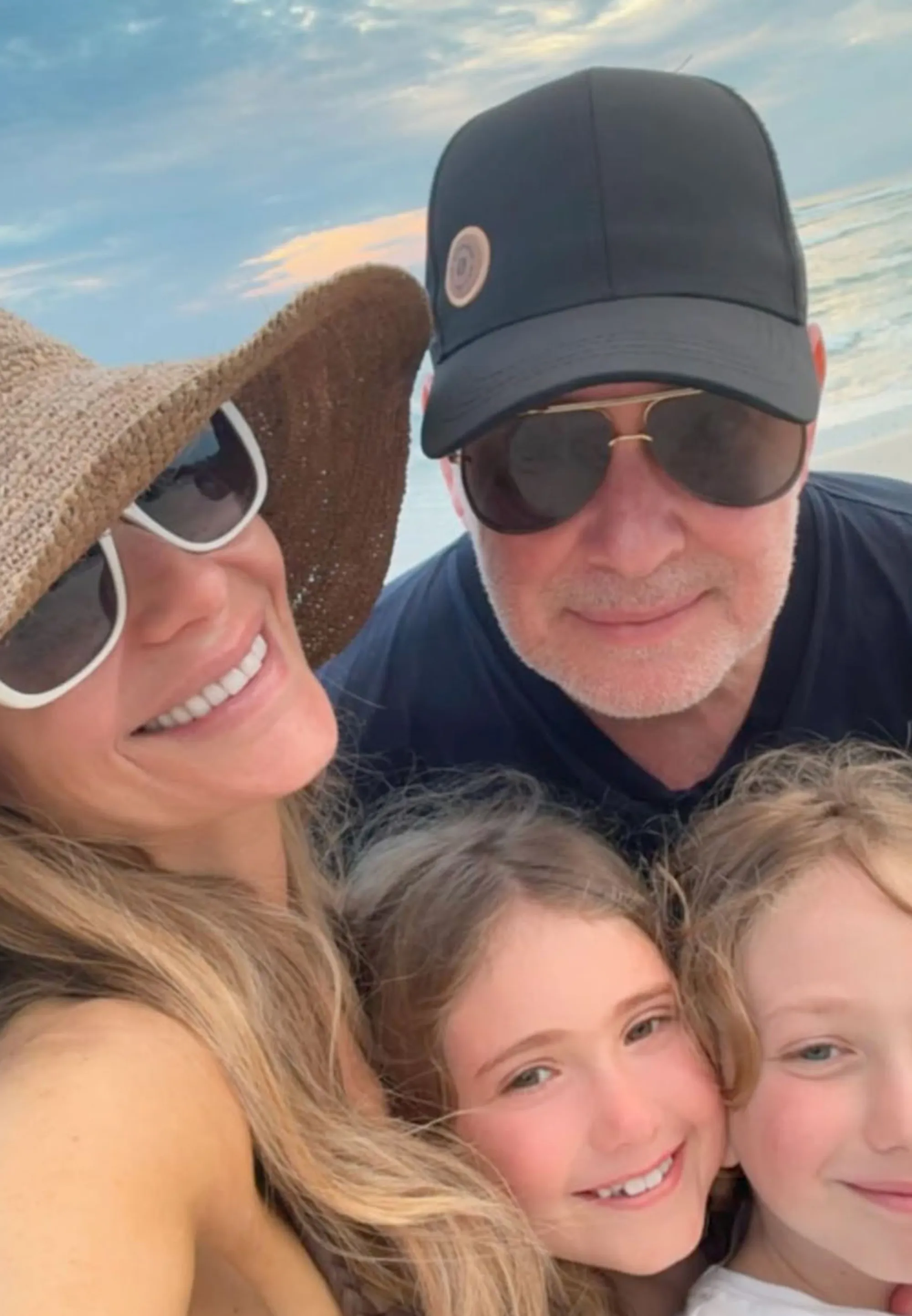 Dorit Kemsley, PK Kemsley, and their two children pose for a selfie on a beach.