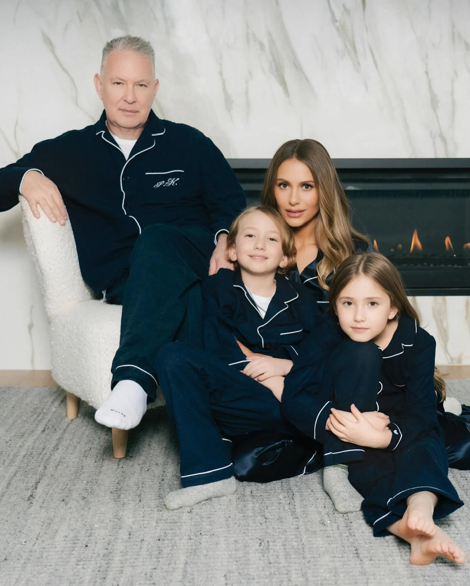 Dorit Kemsley and PK with their two children posing in matching navy pajamas.