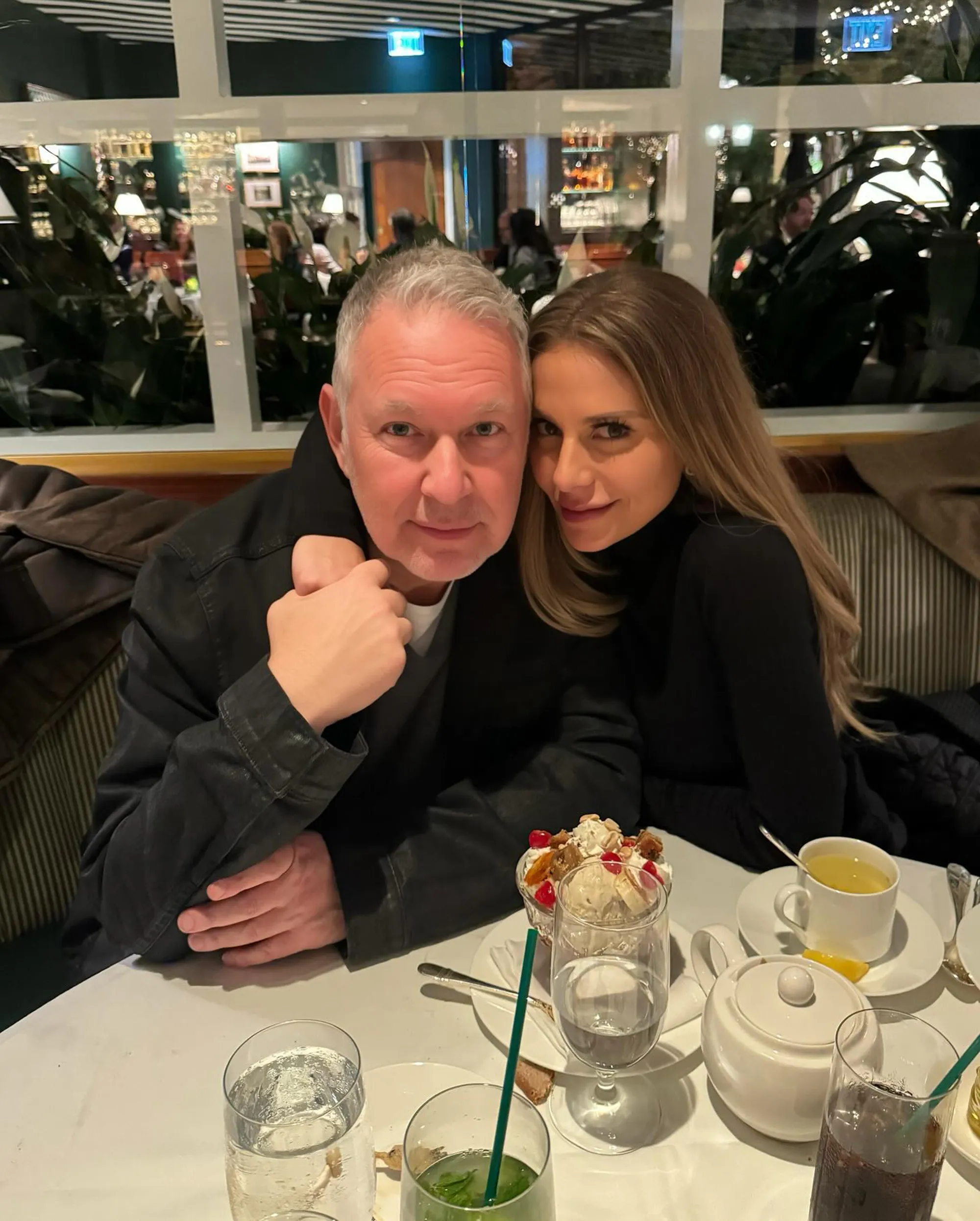 Dorit Kemsley and PK Kemsley seated at a restaurant table.