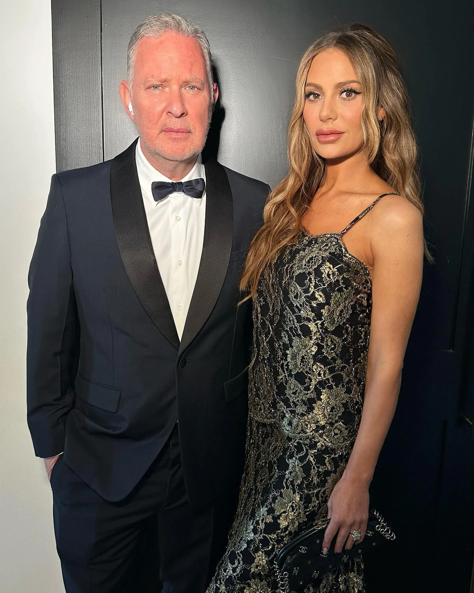 Dorit Kemsley in a black and gold dress next to Paul Kemsley in a tuxedo.