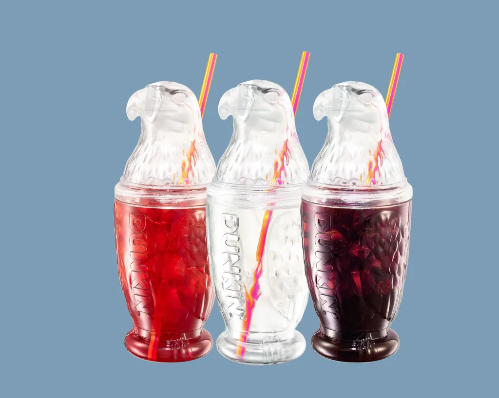 Three Dunkin' Eagle Cups, one filled with red liquid, one with clear liquid, and one with dark liquid.