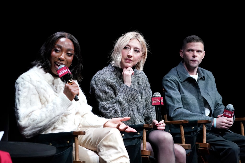 Ego Nwodim, in a white jacket and white pants, Heidi Gardner, in a grey sweater, and Mikey Day, in a grey jacket and white T-shirt and black pants, speaking at the SAG-AFTRA Foundation event.