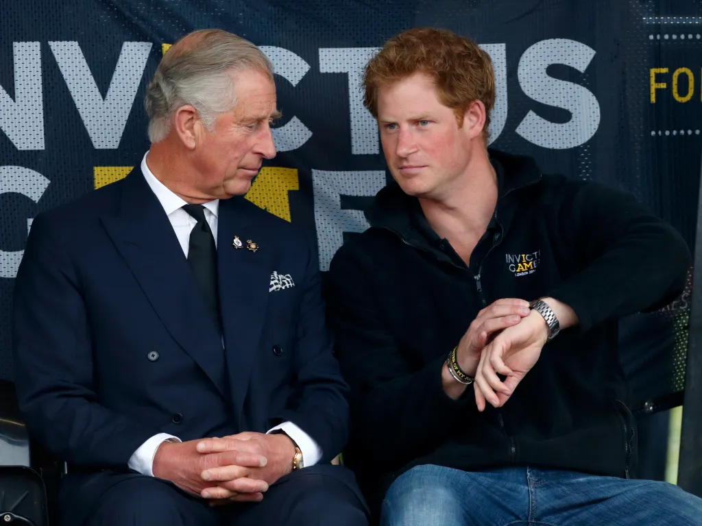 Prince Charles and Prince Harry sitting at the Invictus Games.