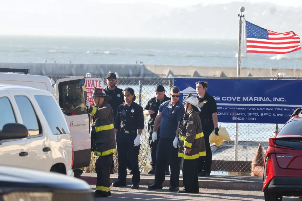 Emergency responders transfer a deceased victim from a boat accident to a van at Fort Mason.